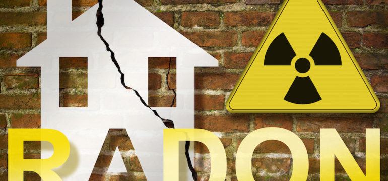 The danger of radon gas in our homes - concept with an outline of a small house with radon text against a damaged, cracked brick wall and radiation hazard sign.