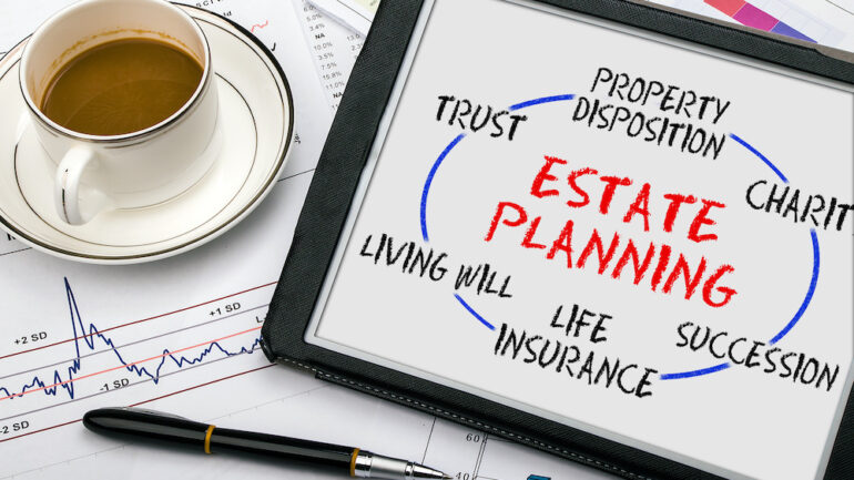 Estate planning concept on a tablet with terms including wills and trusts.