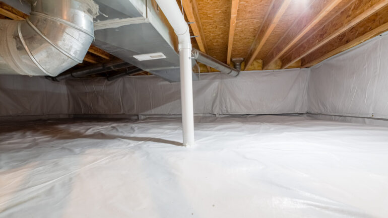 A home crawl space fully encapsulated with a vapor barrier.