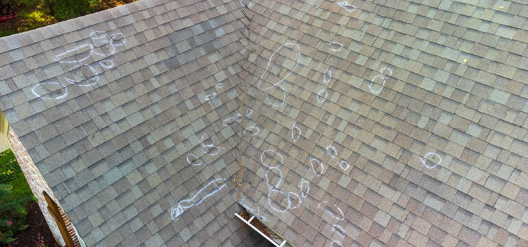 Roof damage from hail with chalk markings from inspection.
