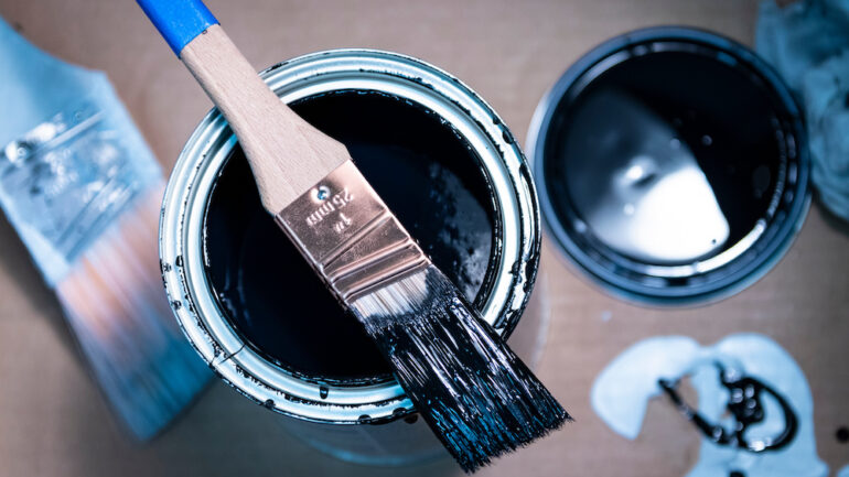 Blue paint spill on a wood floor. Concept of how to remove paint from finished wood.