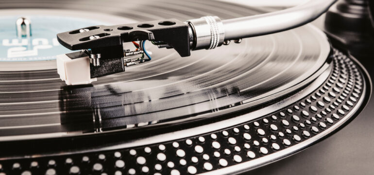 Playing a vinyl albums on turntables.