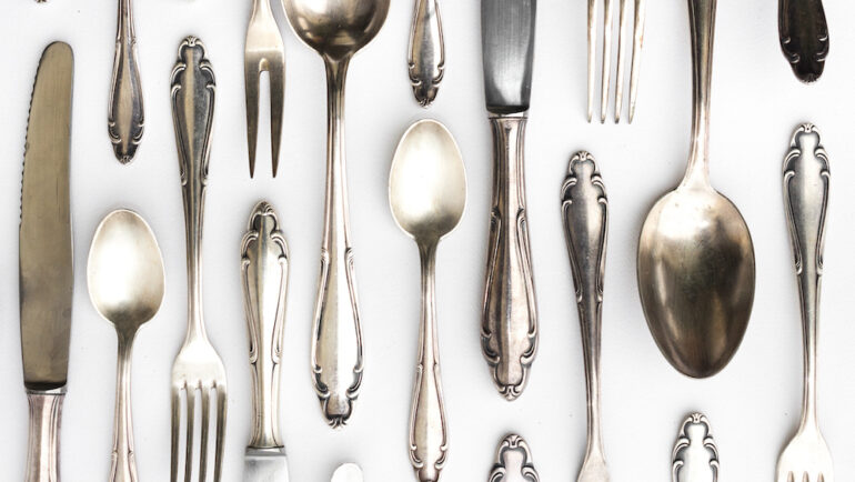 Beautiful sterling silver cutlery collection on a white background.
