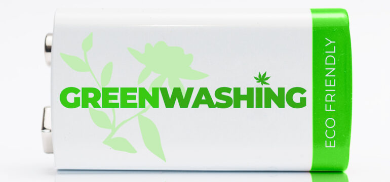 9-volt green and white battery with the word Greenwashing printed on it. Greenwashing is a communication technique aimed at building a false image of a company in terms of environmental impact.