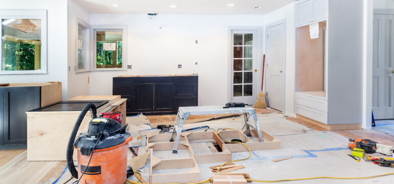 Custom kitchen cabinets in various stages of installation in kitchen remodel.