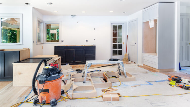 Custom kitchen cabinets in various stages of installation in kitchen remodel.