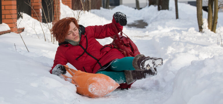 Woman slips on the slippery ice and snow, showing what happens when someone is injured on your property.