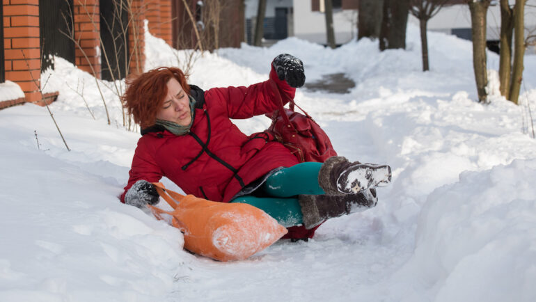 Woman slips on the slippery ice and snow, showing what happens when someone is injured on your property.