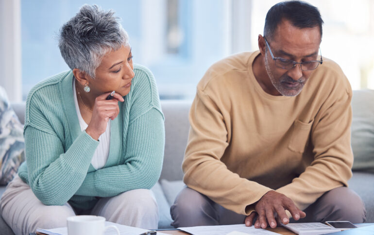 Senior couple reviewing life insurance documents.