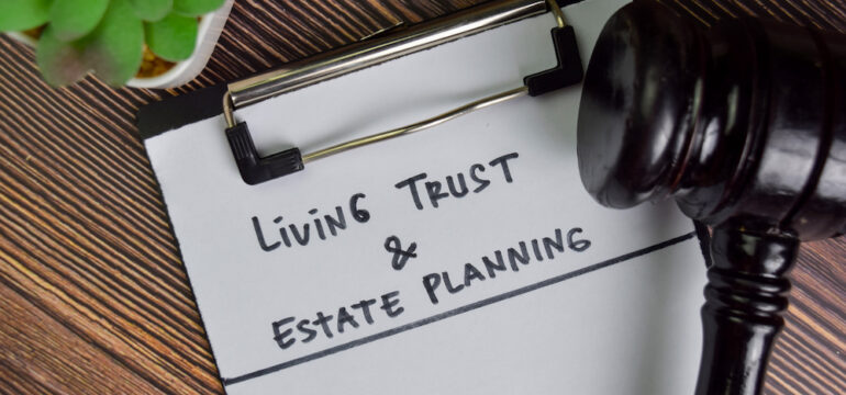 Living Trust and estate planning documents on a wooden table with a judge's gavel.