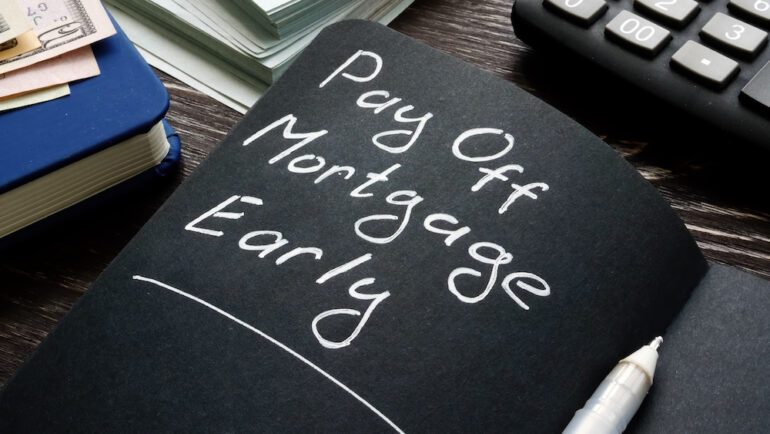 Accelerating Your Mortgage Payments. Pay off mortgage early memo on the black page.