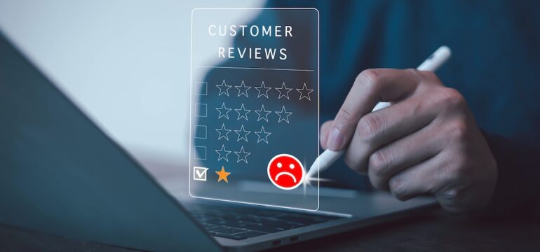 Image of man writing a negative contractor reviews with star ratiings.