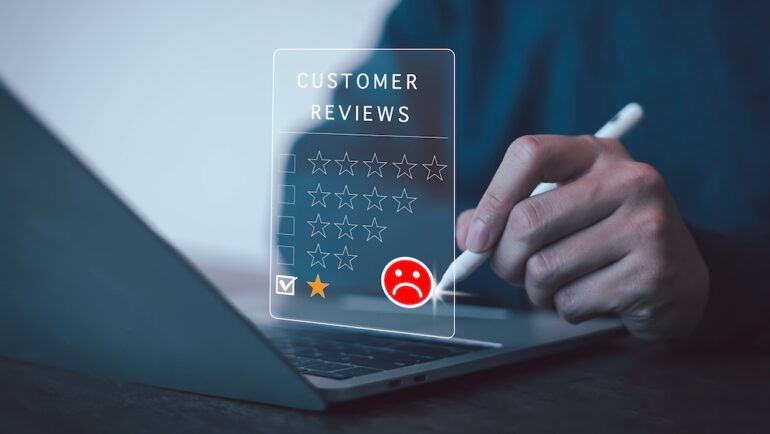 Image of man writing a negative contractor reviews with star ratiings.