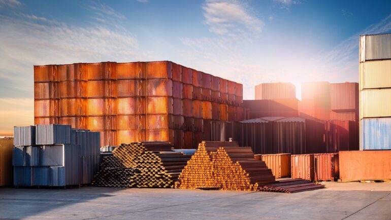 Image of imported steel and building materials on a loading dock to display the concept of how tariffs might affect the housing market.