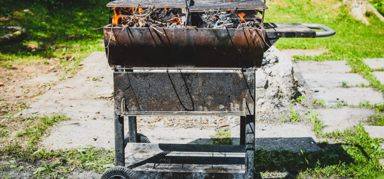Burning and preheating the old rusty barbecue grill.