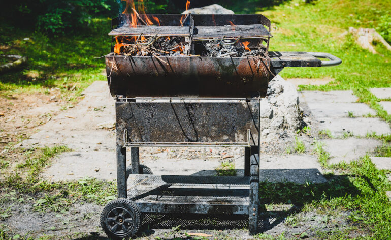 Burning and preheating the old rusty barbecue grill.