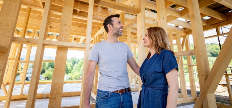Couple make their dreams of building their own home come true visiting new home build and wonder if they should have their own real estate agent for new construction.