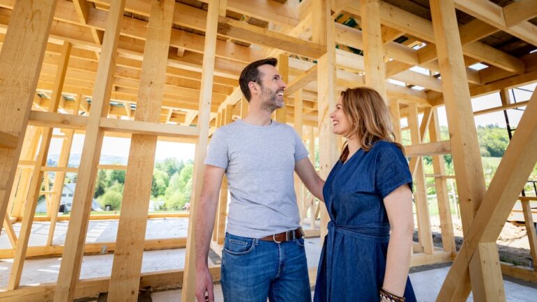Couple make their dreams of building their own home come true visiting new home build and wonder if they should have their own real estate agent for new construction.