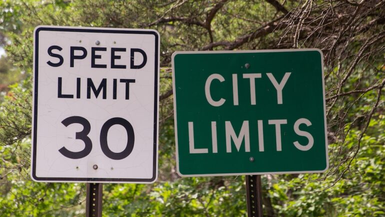 Street sign indicating city limits that is related to understanding extra-territorial jurisdiction.