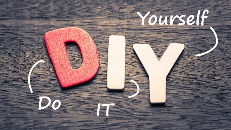 Wood letters of DIY acronym and definition on wood background.